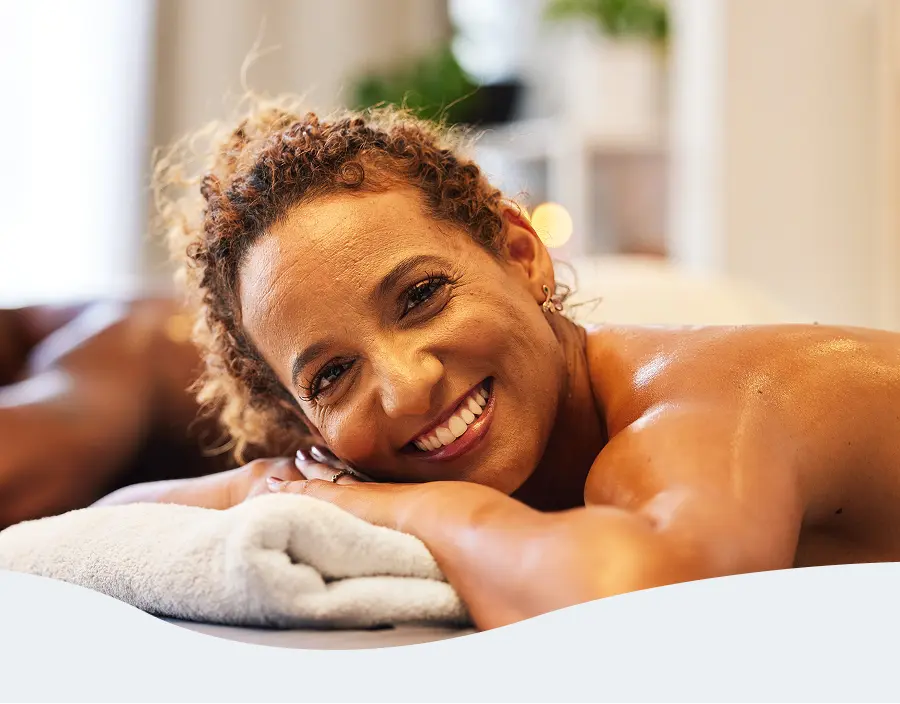 Woman enjoying a back massage at Pause Spa