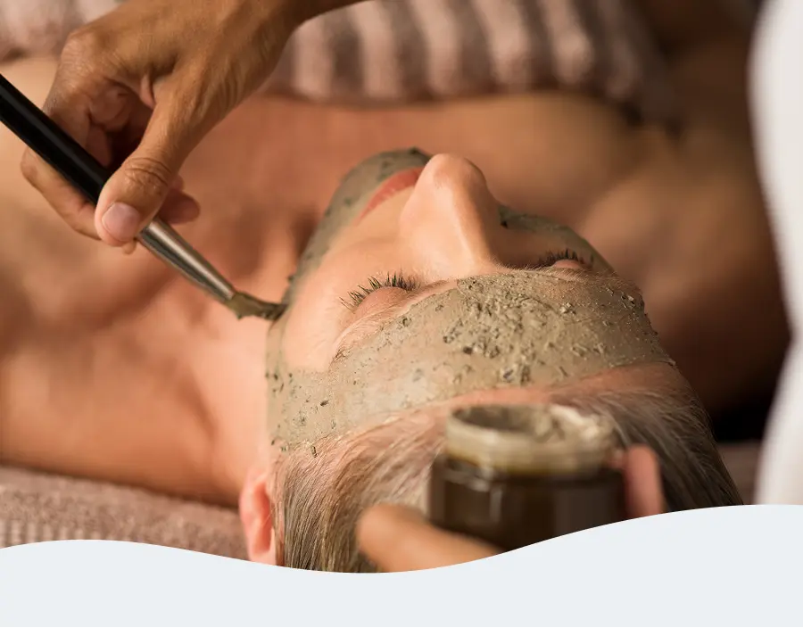 Woman receiving a facial treatment at Pause Spa