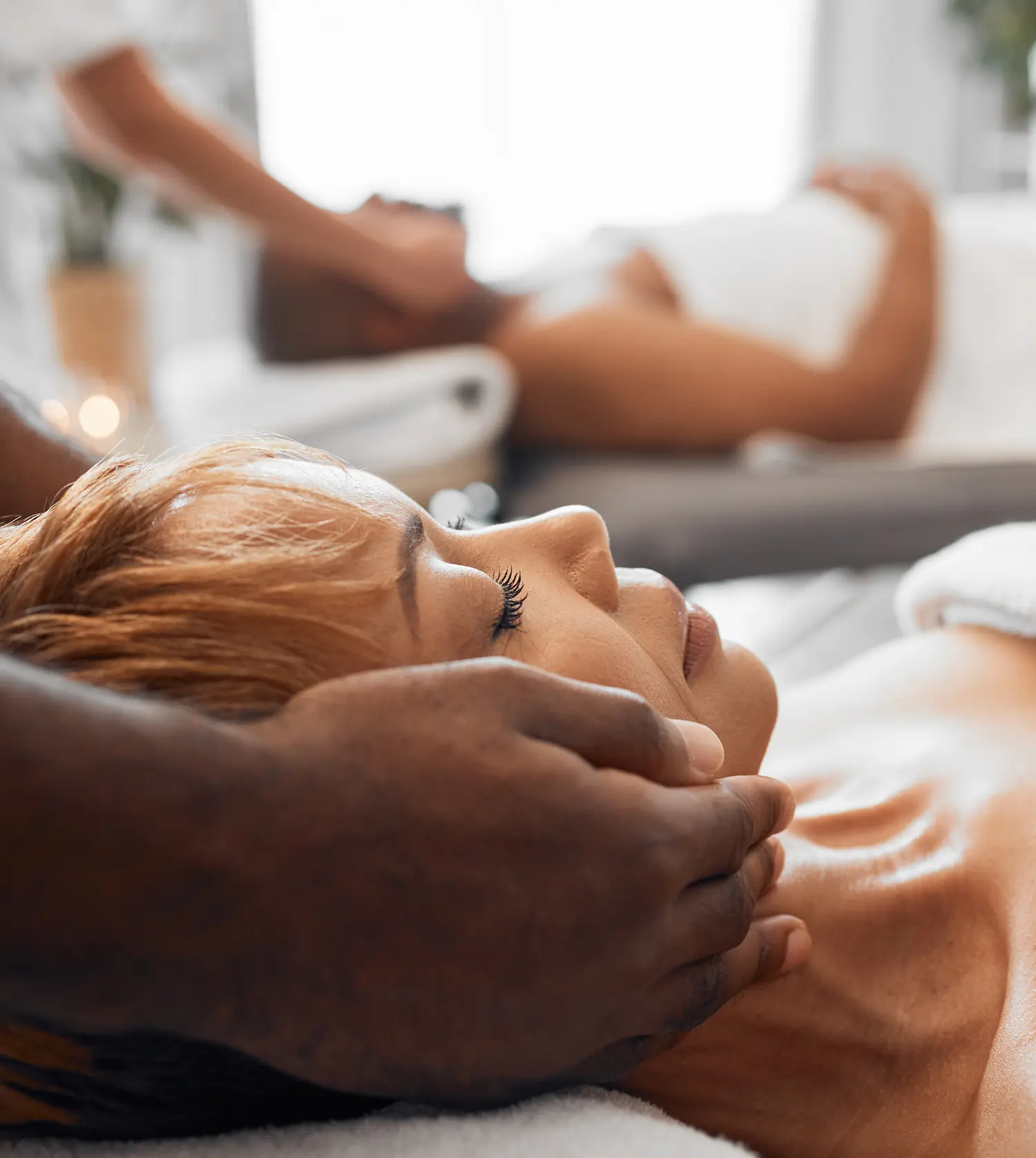 African woman and her husband enjoying a soothing neck massage together during their Couple Full-Body Massage experience at Pause Spa