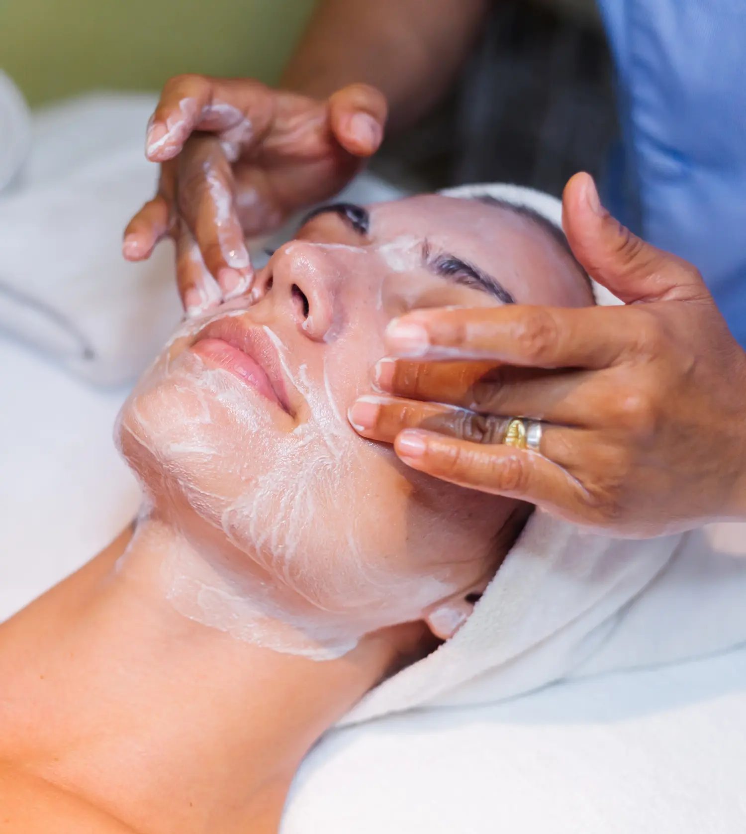 Therapist performing a Hydrating/Balancing Facial treatment on a client at Pause Spa