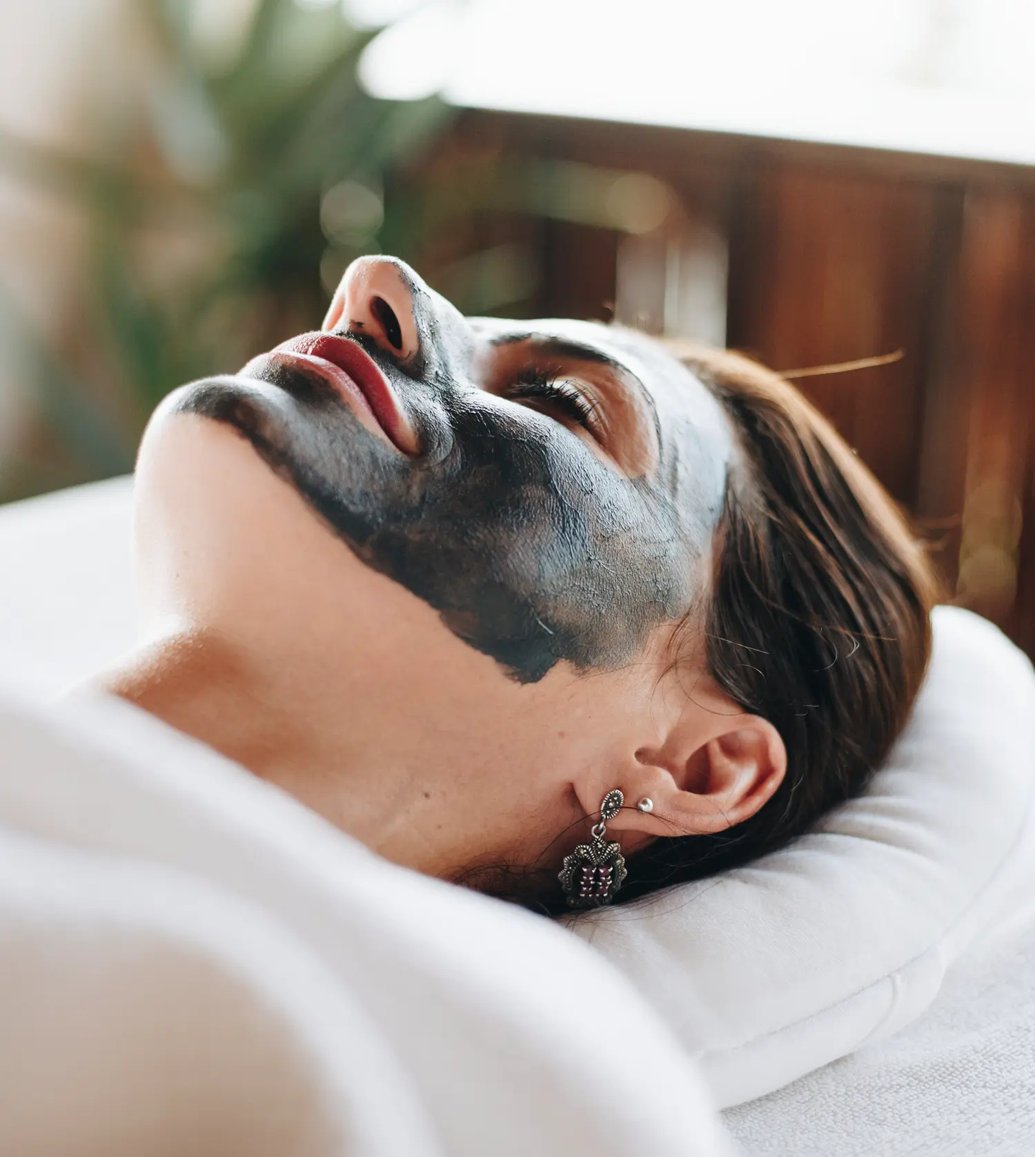 Woman enjoying a relaxing Essential Care Facial treatment at Pause Spa
