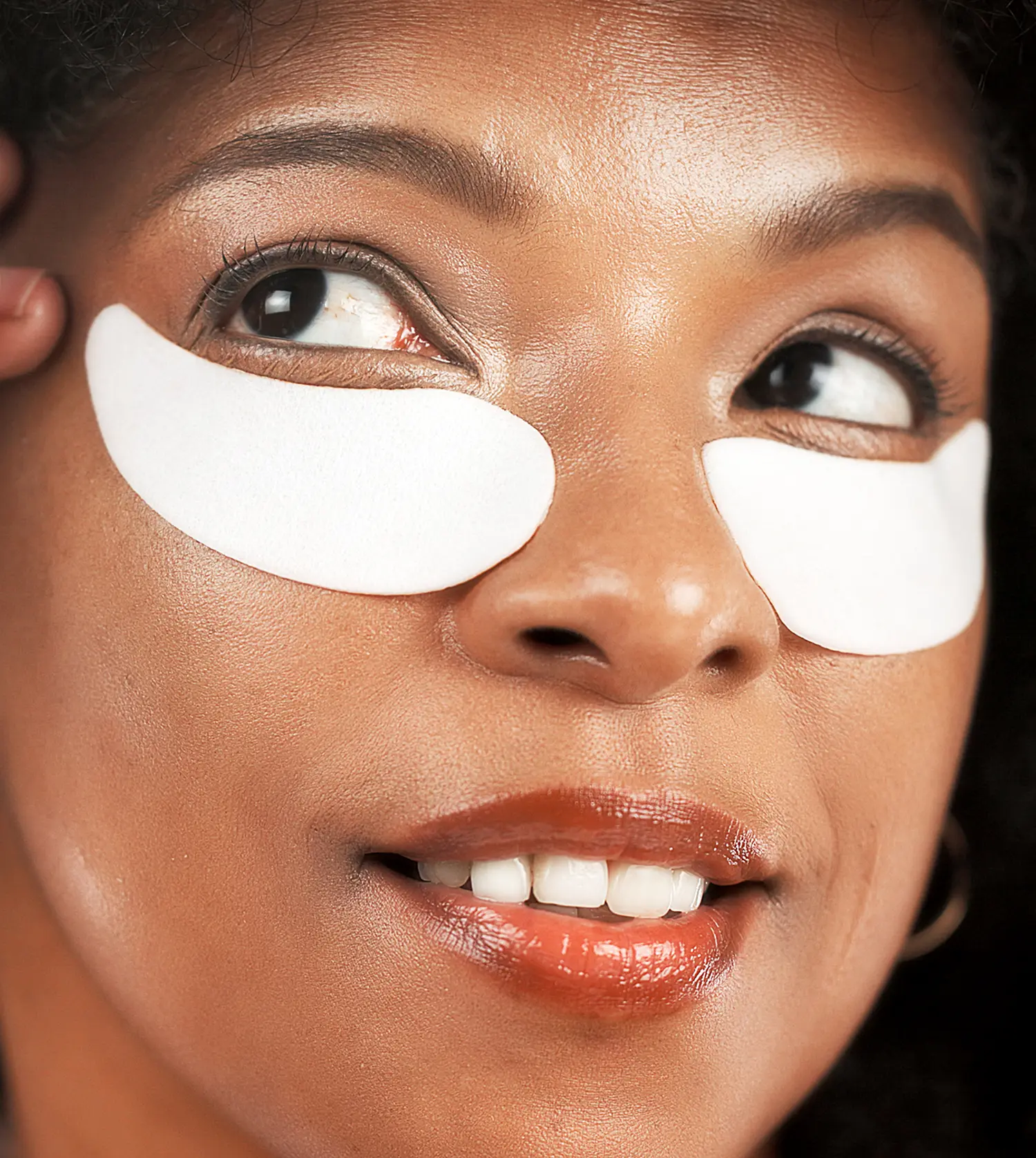 African woman enjoying a Collagen Eye Treatment at Pause Spa