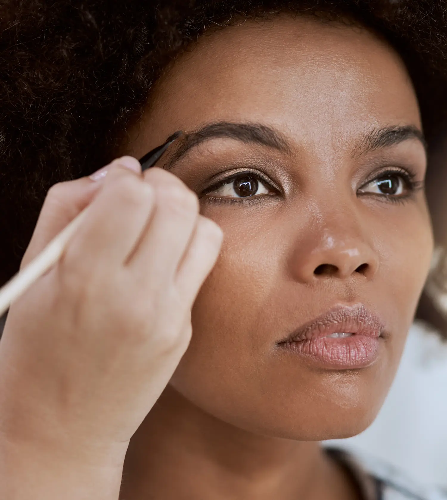 Therapist applying tint to a client's eyebrows during her Brow Tint experience at Pause Spa